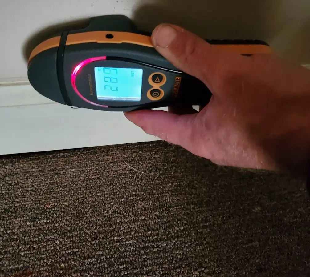 Moisture detection at baseboard during Storm Damage Restoration in Powell